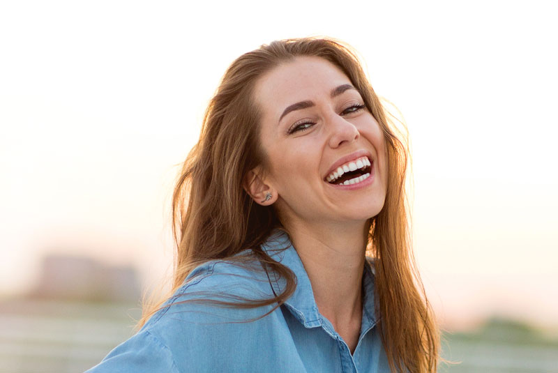 whitening patient at beach with new smile