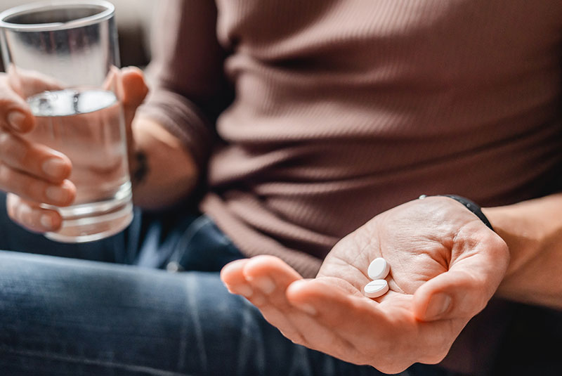patient taking medication after their dental procedure