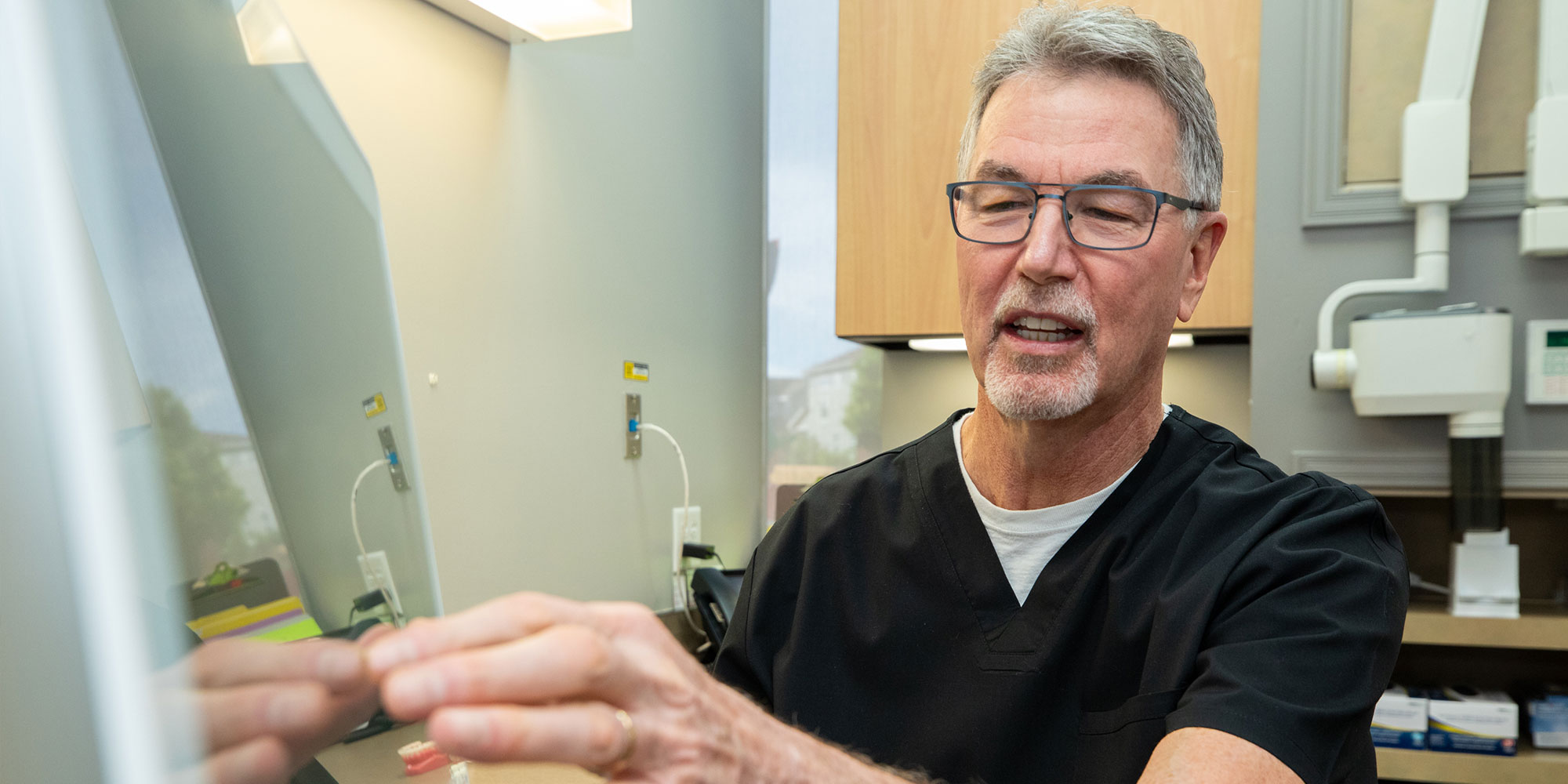 Doctor showing patient digital information for dental procedure