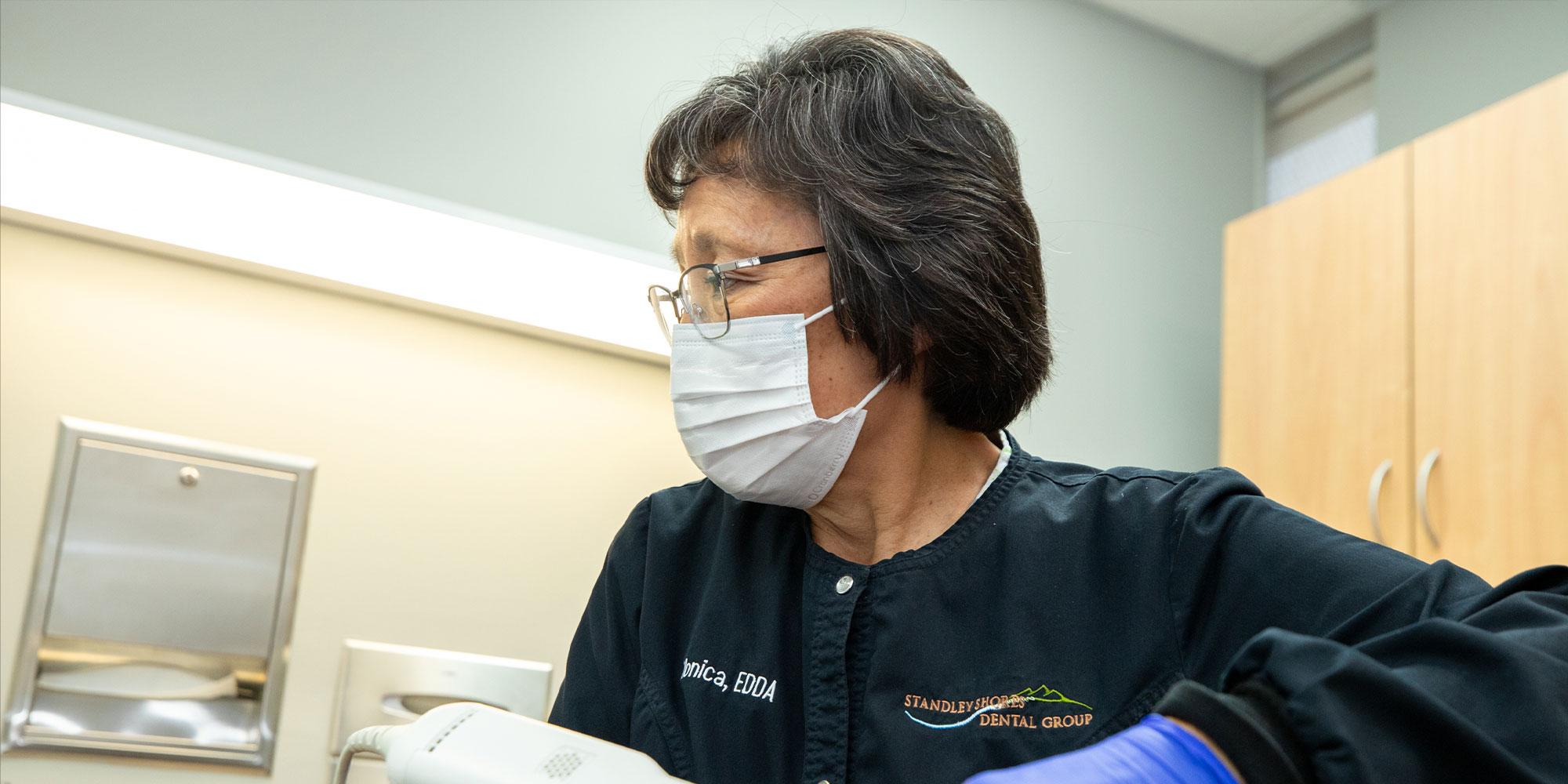 staff performing examination for dental procedure