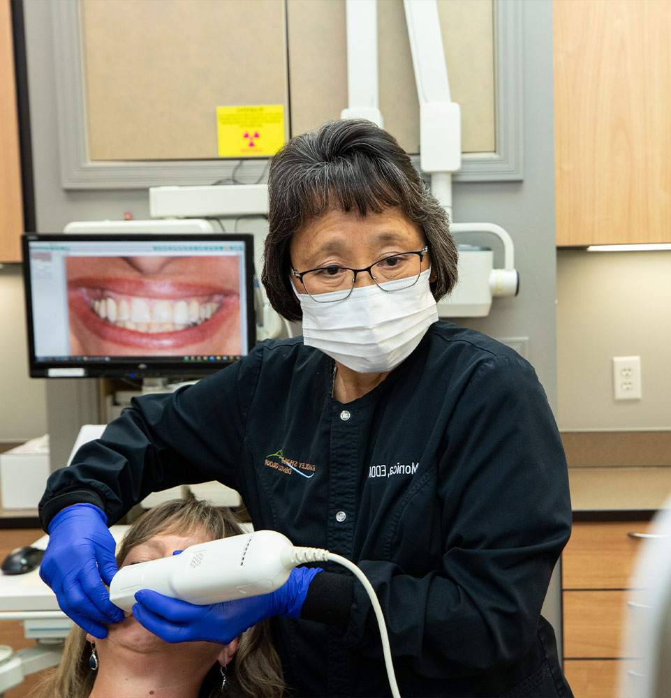 staff member performing dental examination with patient with in the dental practice