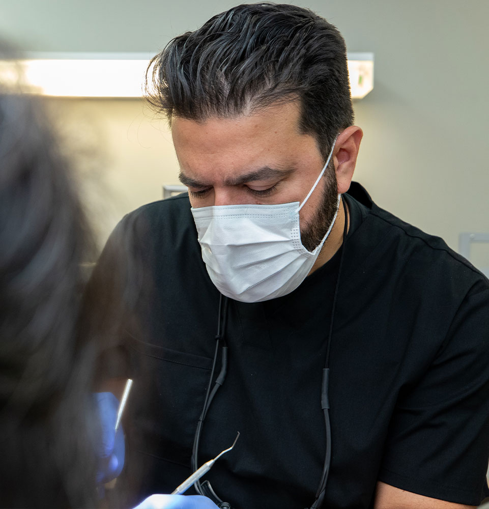 doctor peroforming dental procedure within the dental practice