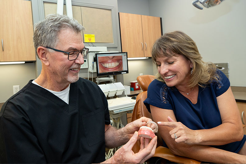 patient and doctor looking at arch model within the dental practice