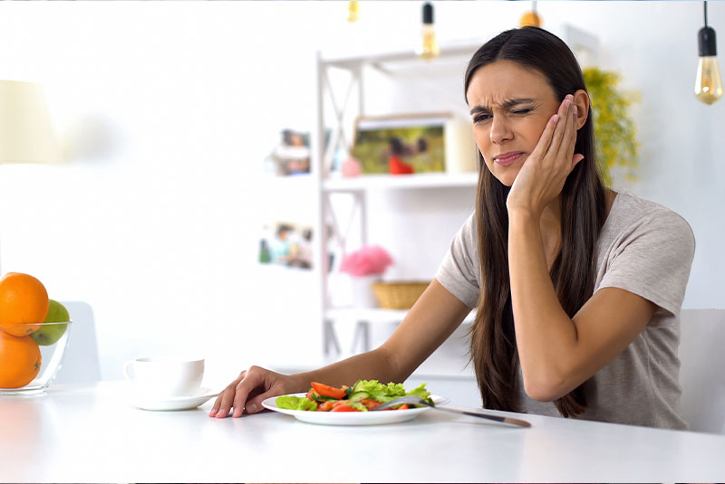 patient enduring mouth pain with trying to have food
