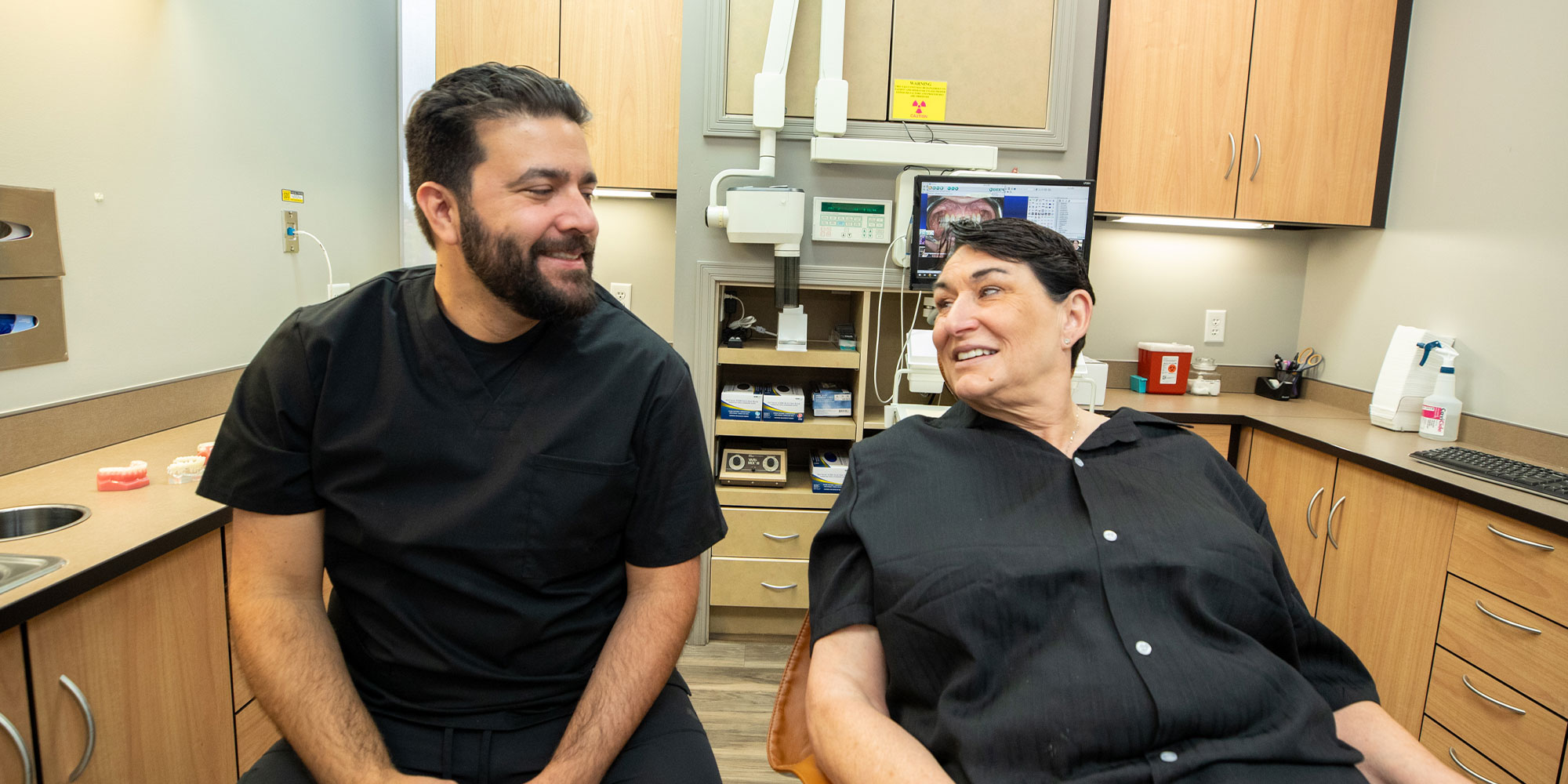 doctor and patient discussing dental procedure within the dental practice