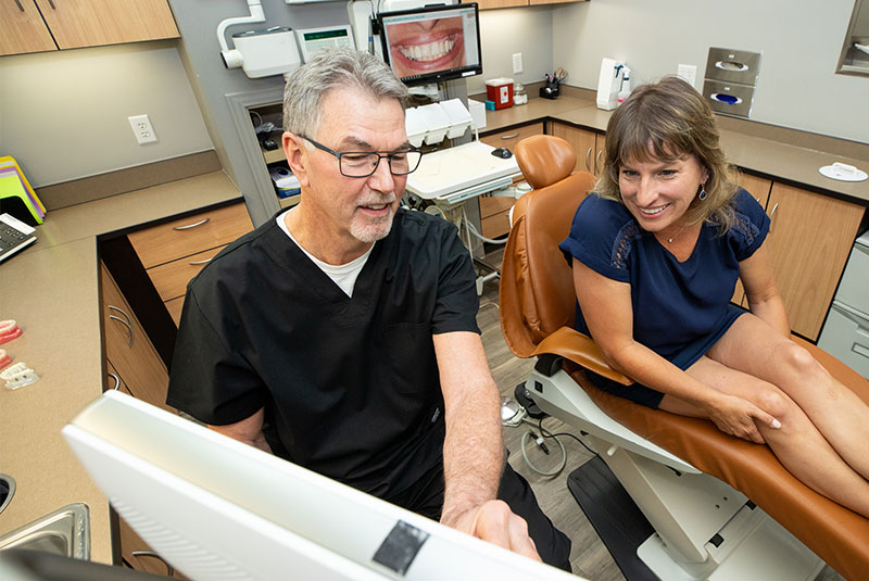Patient and staff member looking over dental procedure