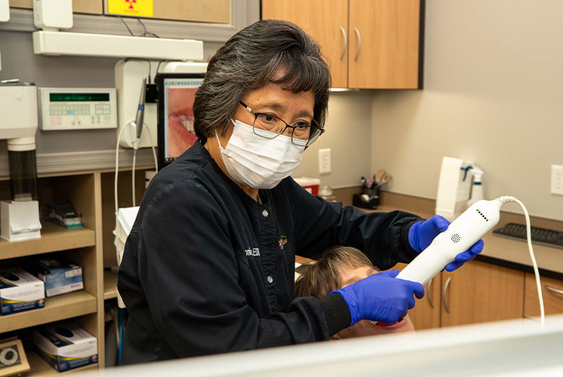 staff member performing dental procedure within the dental practice